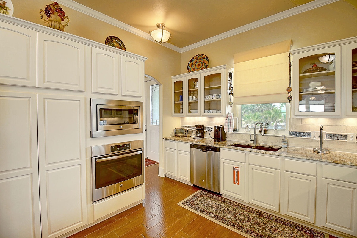 Your gourmet kitchen features granite counters, stainless steel appliances, and elegant white cabinetry for memorable cooking experiences.