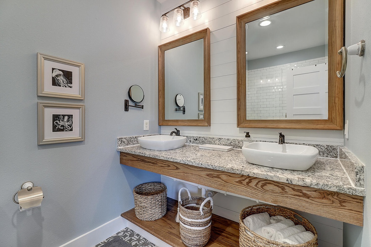 Step into your luxurious dual-vanity bathroom featuring marble countertops, vessel sinks, and rustic wood accents for your morning routine.