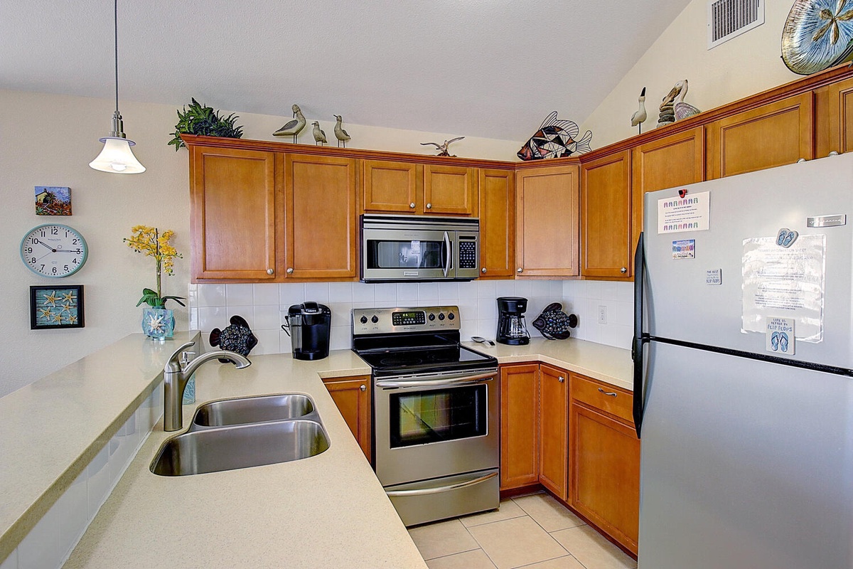 Your fully equipped kitchen features warm wood cabinets, stainless steel appliances, and plenty of counter space for preparing vacation meals.