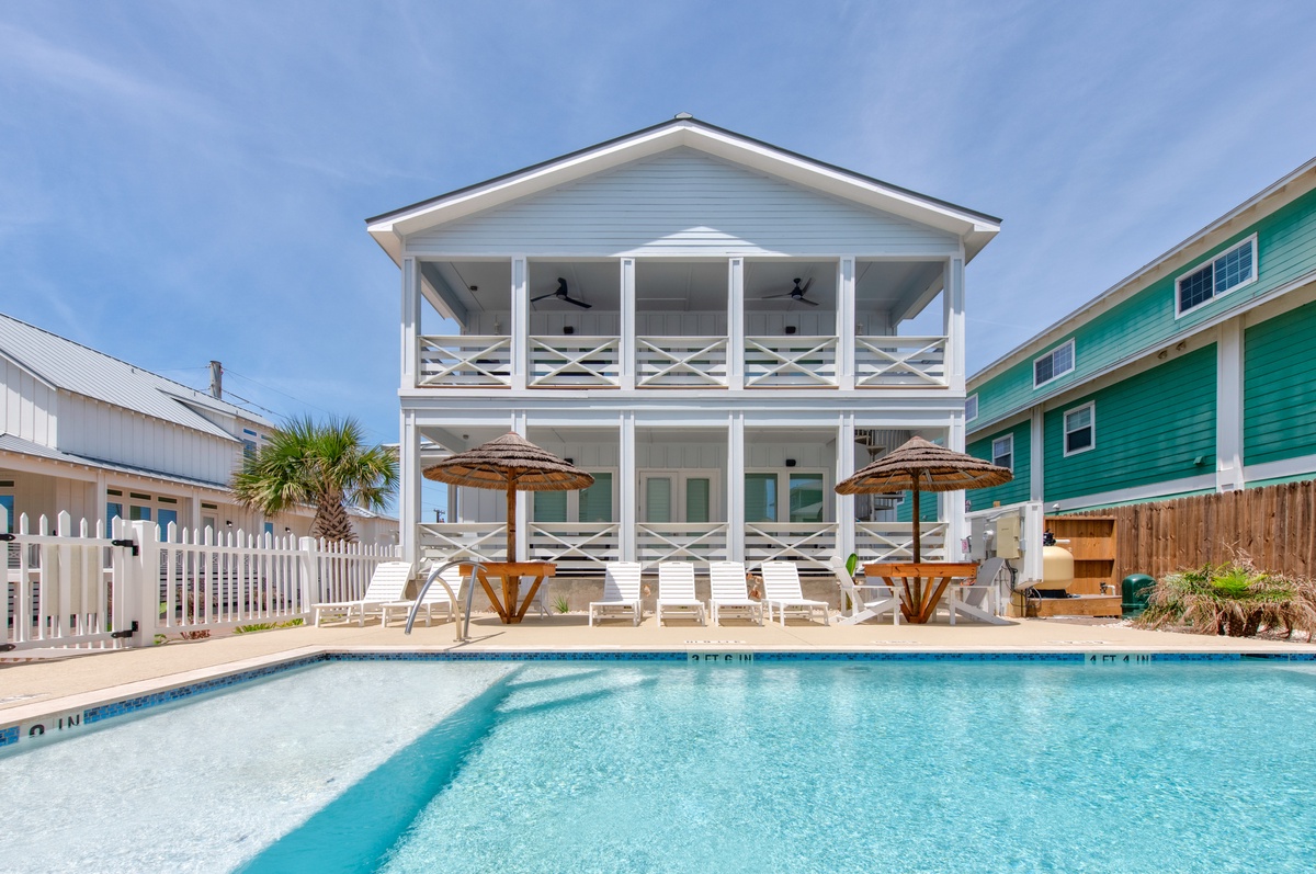 Pristine community pool, shaded umbrellas, and double-deck porches perfect for seaside relaxation.