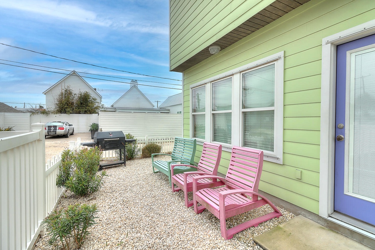 Relax on your private patio with colorful seating and BBQ grill, perfect for morning coffee or evening grilling sessions.