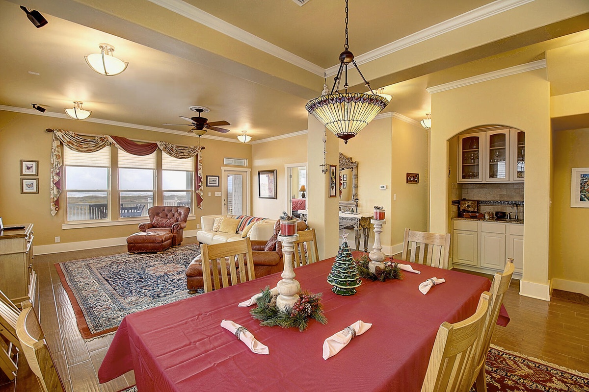 Gather around this elegant dining table where warm memories unfold over delicious meals, with your comfortable living area just steps away.