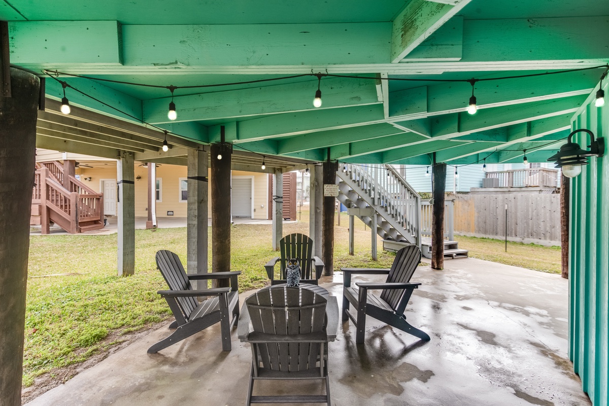 Unwind in your private covered patio with comfortable seating and string lights creating the perfect ambiance for evening conversations.
