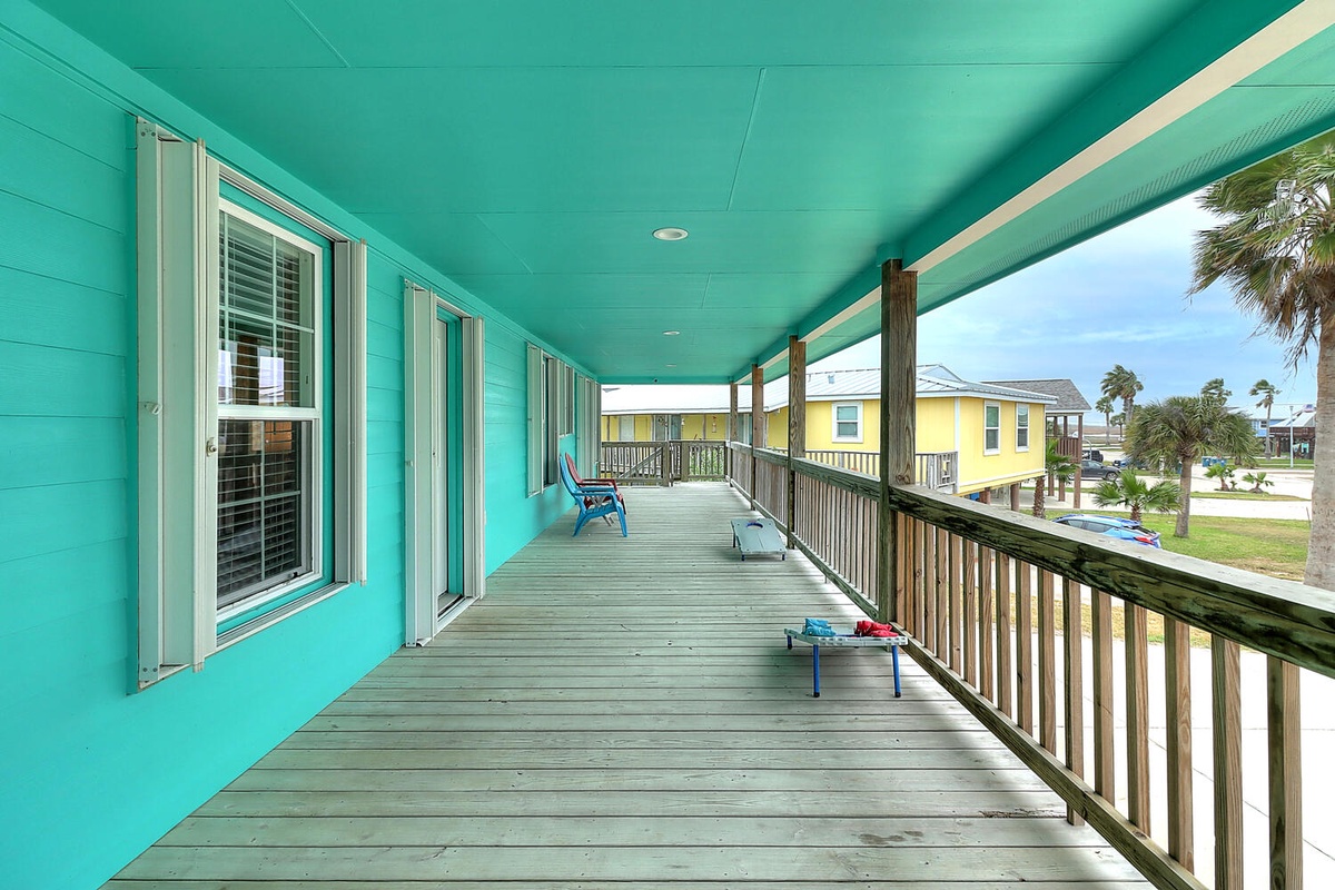 Step onto your spacious covered deck where beach chairs await and colorful island charm surrounds you with tropical views.