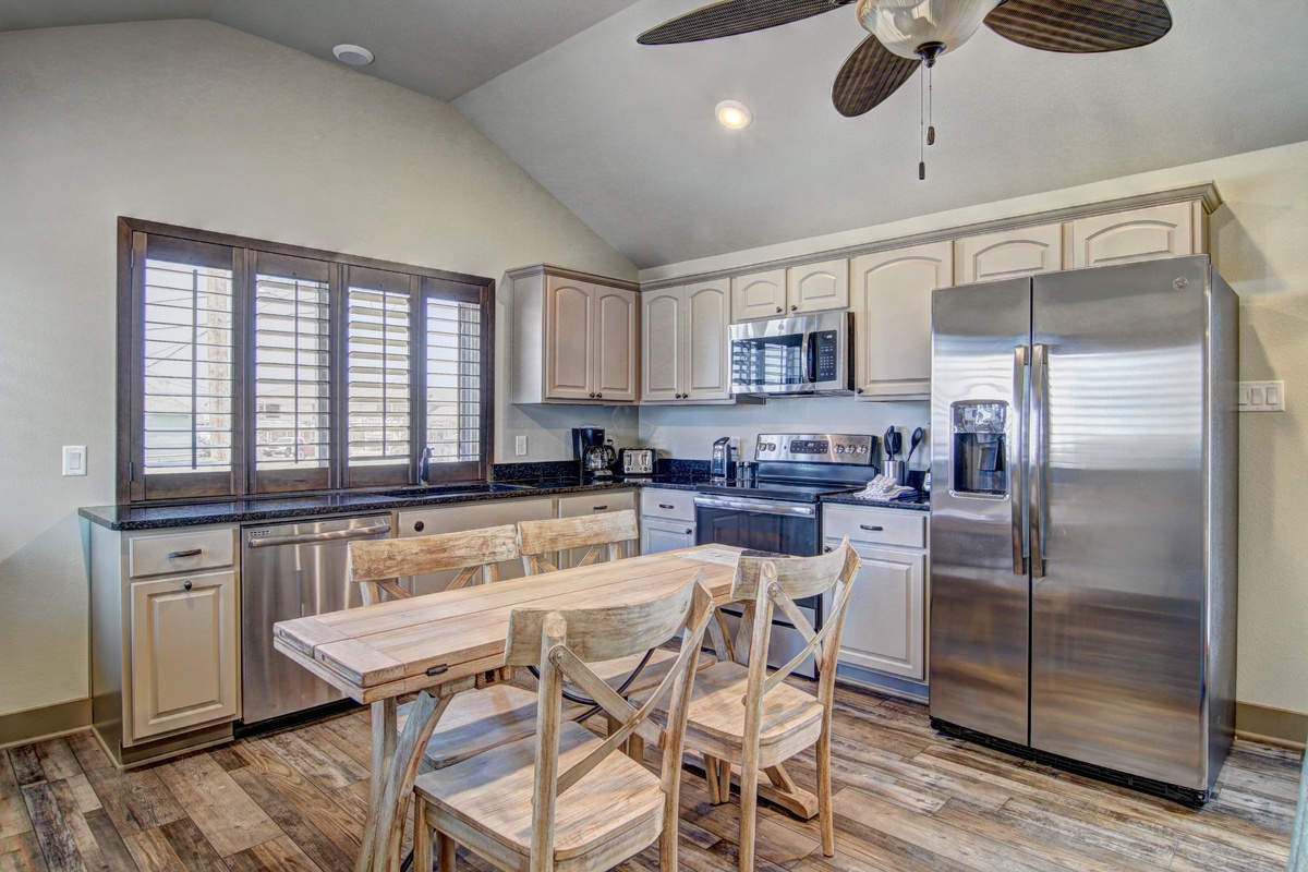 Your spacious kitchen awaits with stainless steel appliances, granite counters, and a cozy dining table where you'll enjoy memorable meals together.