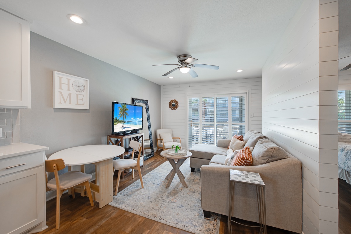 Unwind in your stylish living space with cozy sectional seating, modern entertainment center, and charming dining nook perfect for morning coffee.