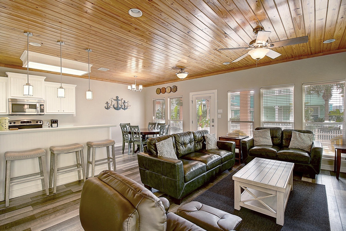 Unwind in this beautifully designed open-concept space where rustic wood ceilings meet modern comfort, perfect for your group gatherings.