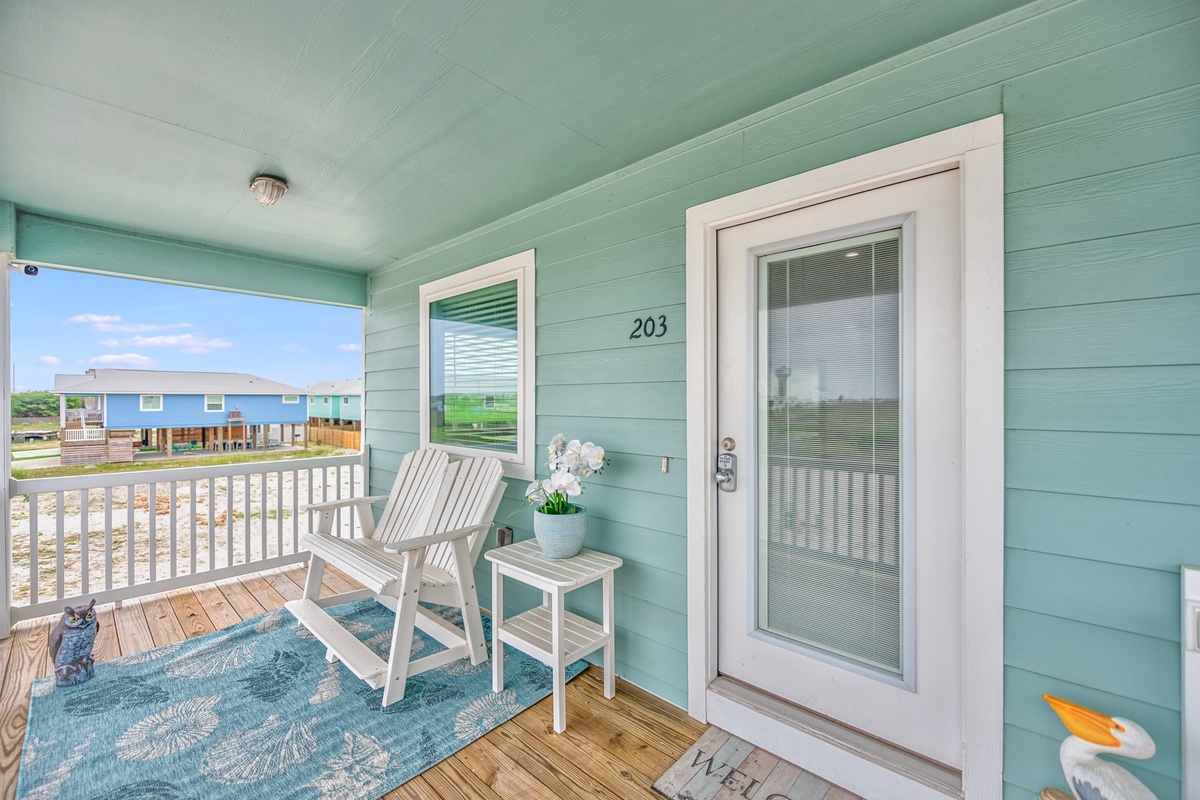 Your charming seaside retreat awaits with a welcoming porch where you can sip morning coffee in coastal comfort.