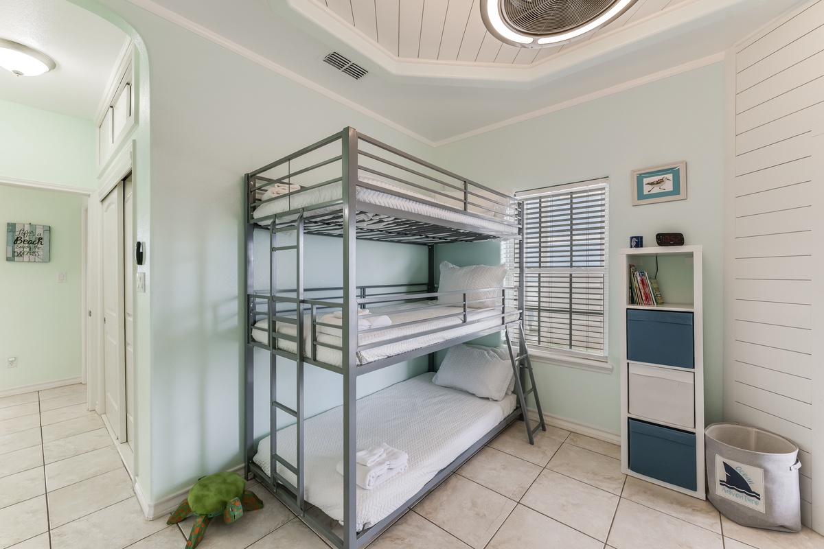 Your family's seaside retreat features cozy triple bunk beds and beach-themed touches for memorable nights together.