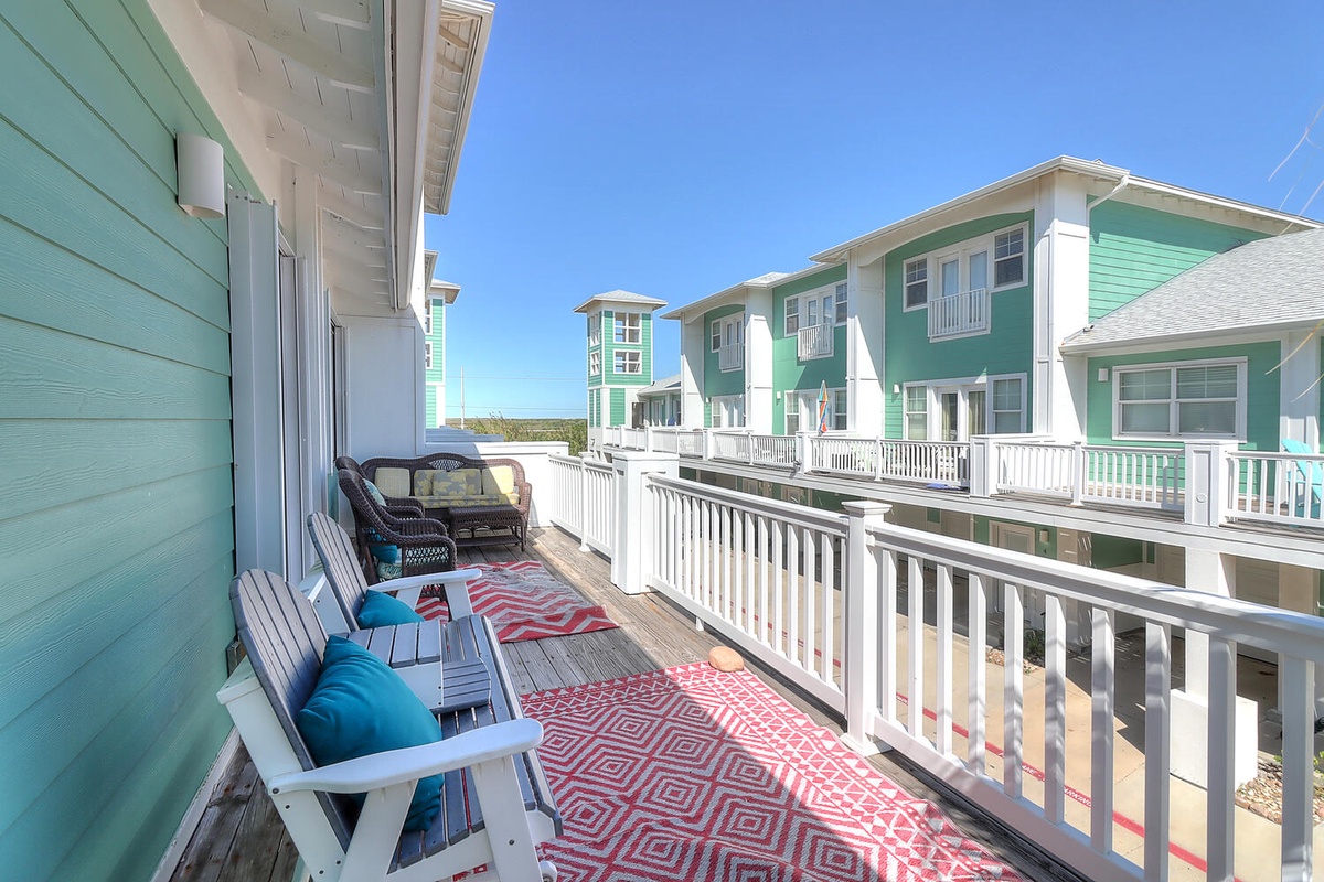 Unwind on your private deck with cozy seating and vibrant coastal charm overlooking the charming neighborhood.