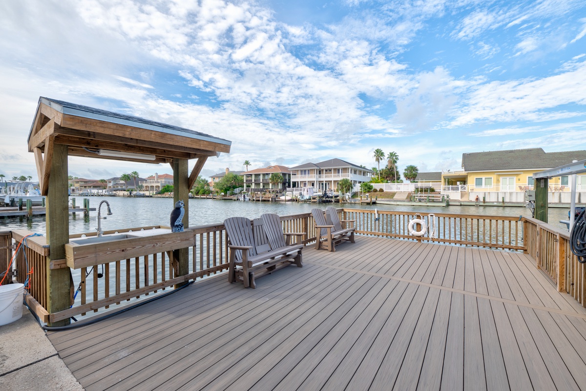 A spacious waterfront deck offers direct canal access, perfect for your morning coffee as boats drift by and palm trees frame the horizon.