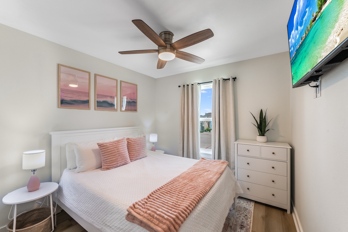 Drift into peaceful sleep surrounded by coastal artwork and soft pink accents, with your private balcony just steps away.