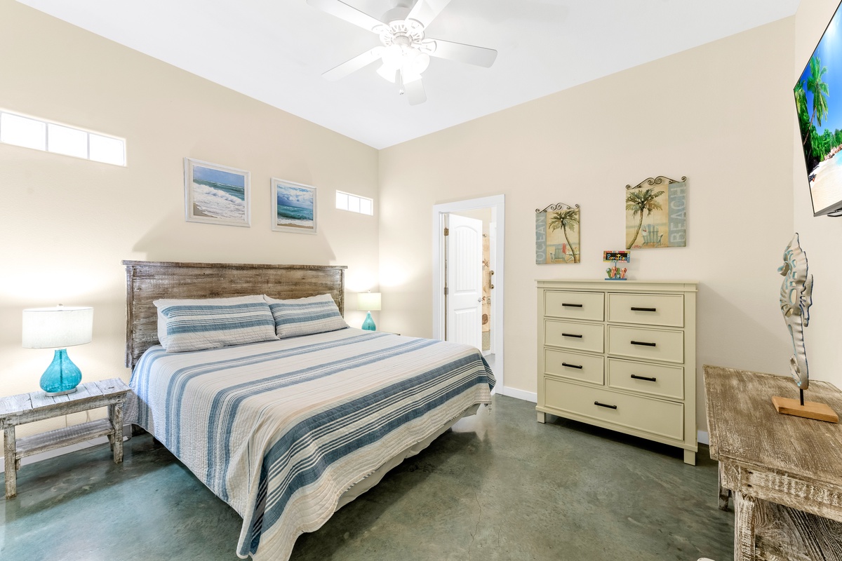 Drift into peaceful dreams in your coastal-themed bedroom, complete with a ceiling fan for comfort and ocean-inspired decor.