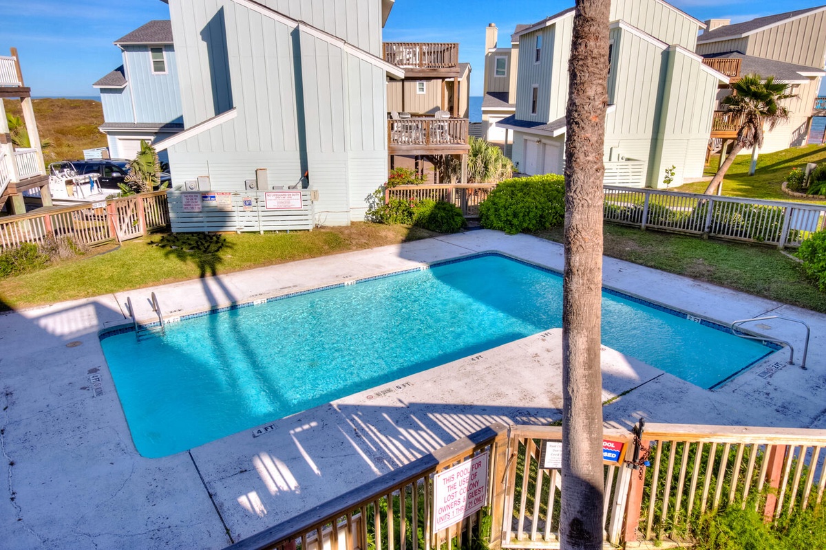 Your private pool paradise awaits with sparkling blue waters perfect for cooling off after sunny beach days in this coastal retreat.