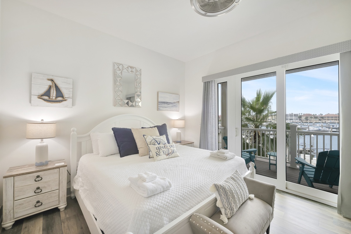 Wake up to stunning marina views from your bright, coastal-themed bedroom with crisp linens and nautical touches creating the perfect seaside retreat.