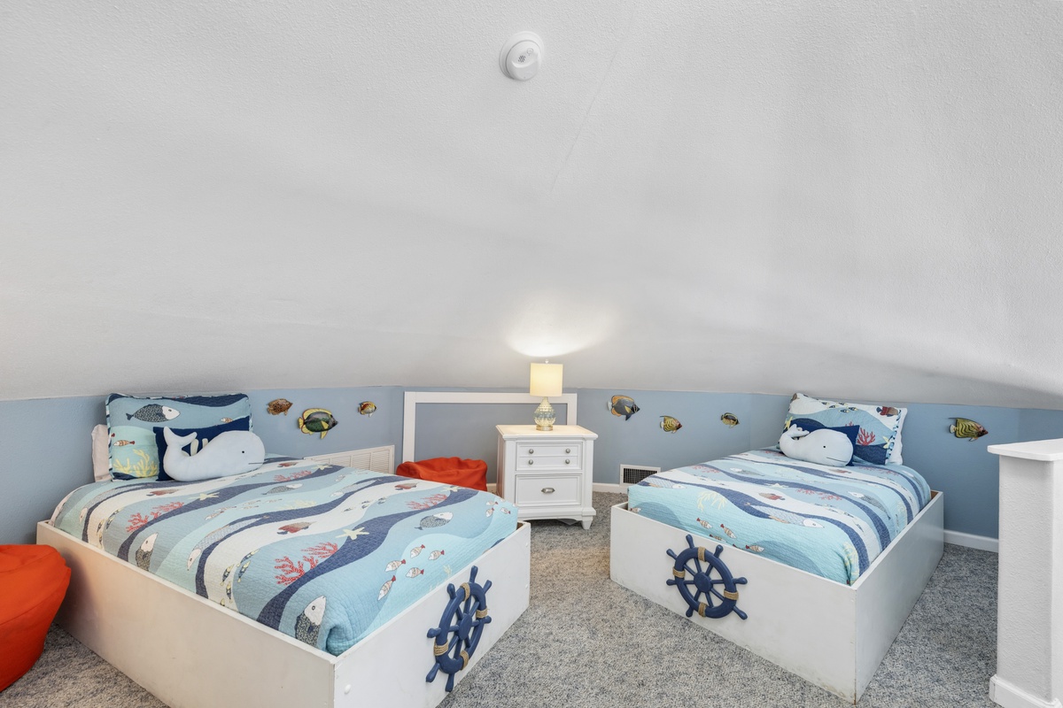 Your little sailors will drift off to sleep surrounded by whales and nautical magic in this charming twin bedroom.
