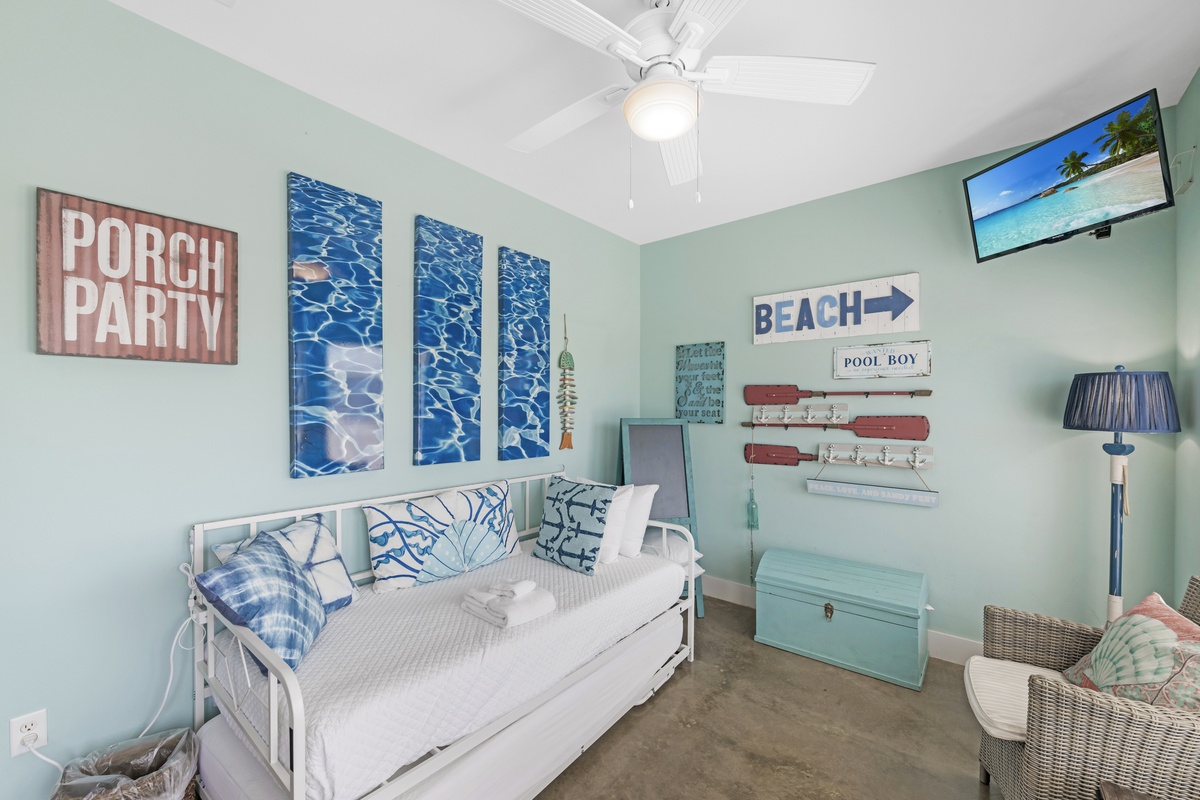 Drift off to sleep in your coastal-themed bedroom, where ocean-blue artwork and beach vibes create the perfect seaside retreat.