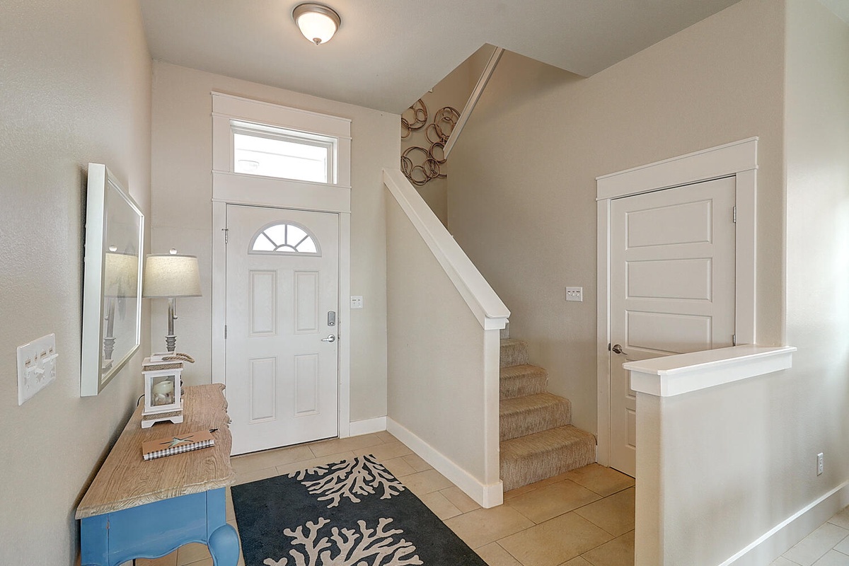 Step into your bright, welcoming entryway with polished tile floors and charming coastal touches that set the tone for your relaxing getaway.