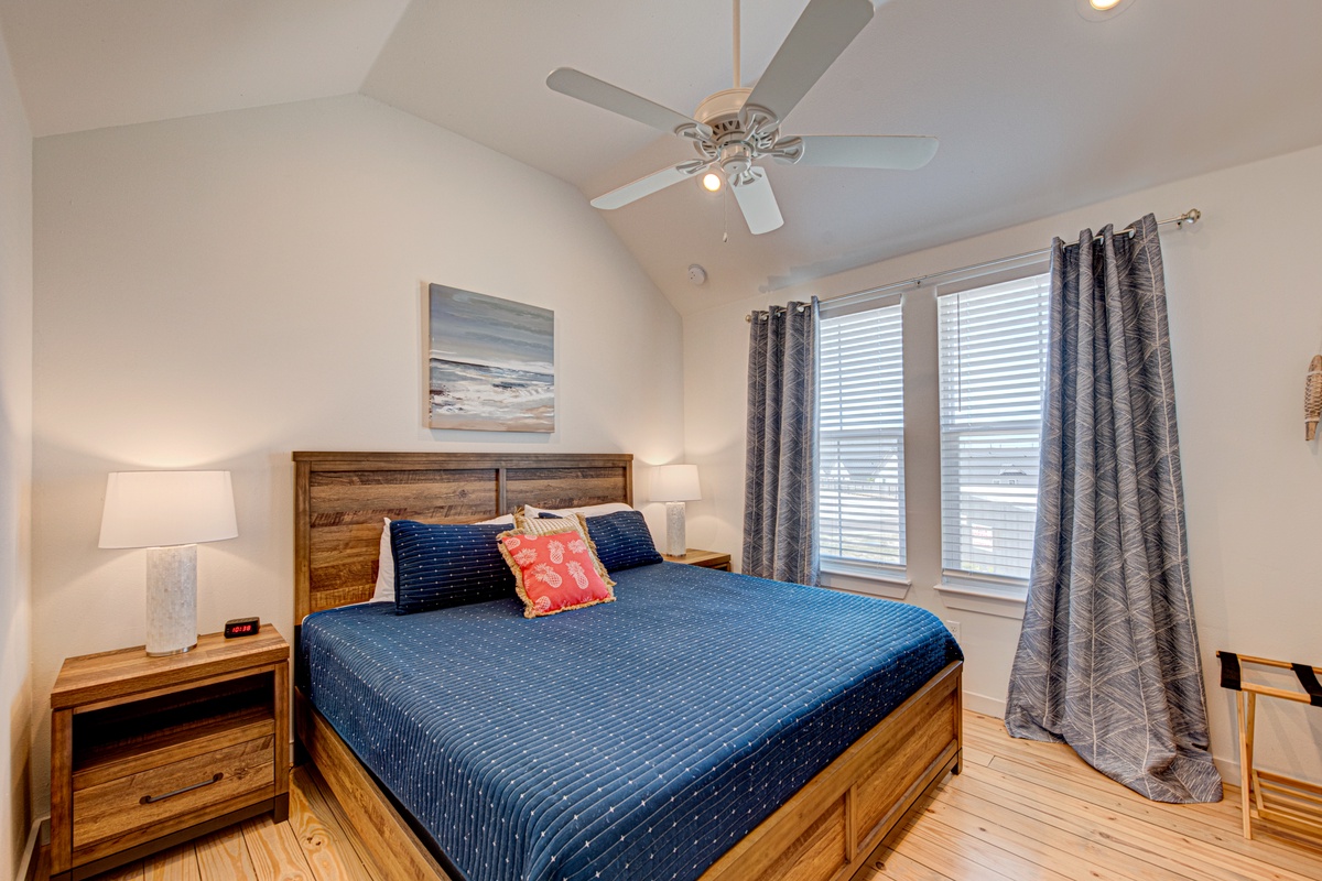 Drift off in your cozy bedroom featuring warm wood furnishings, soft lighting, and thoughtful coastal touches for peaceful nights.