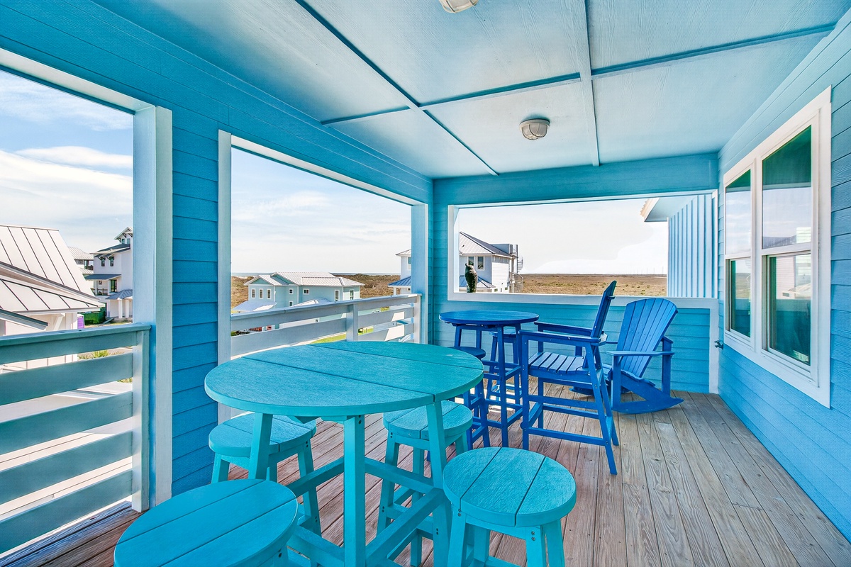 Sip your morning coffee on this vibrant turquoise balcony while enjoying ocean breezes and coastal views.
