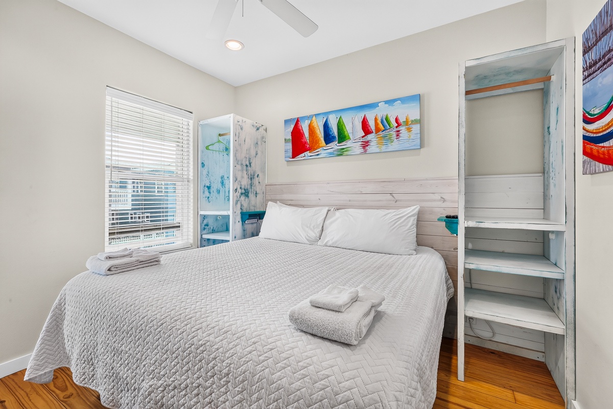 Settle into this bright bedroom and let the coastal breeze from your window refresh you. Your bright, airy bedroom with ceiling fan offers a peaceful retreat after sunny beach days.
