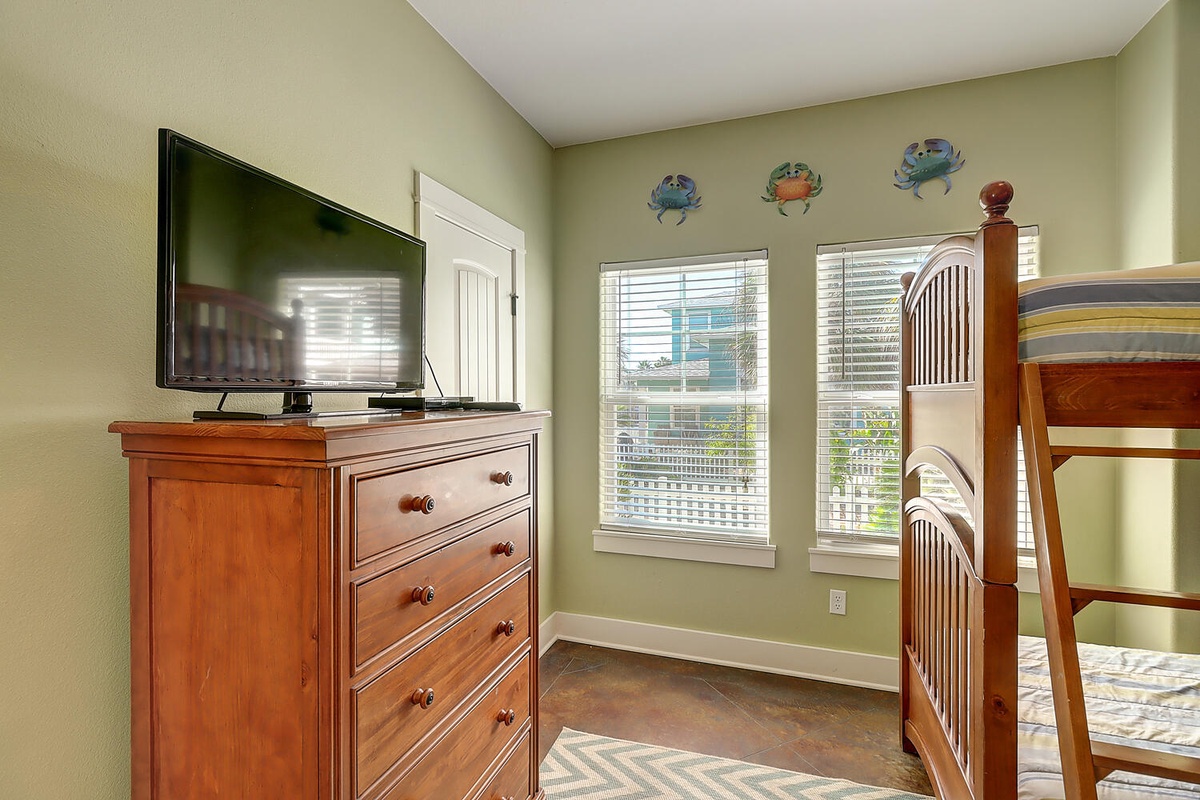 Your kids will love this cozy bunk bed room with TV entertainment and cheerful coastal decor.