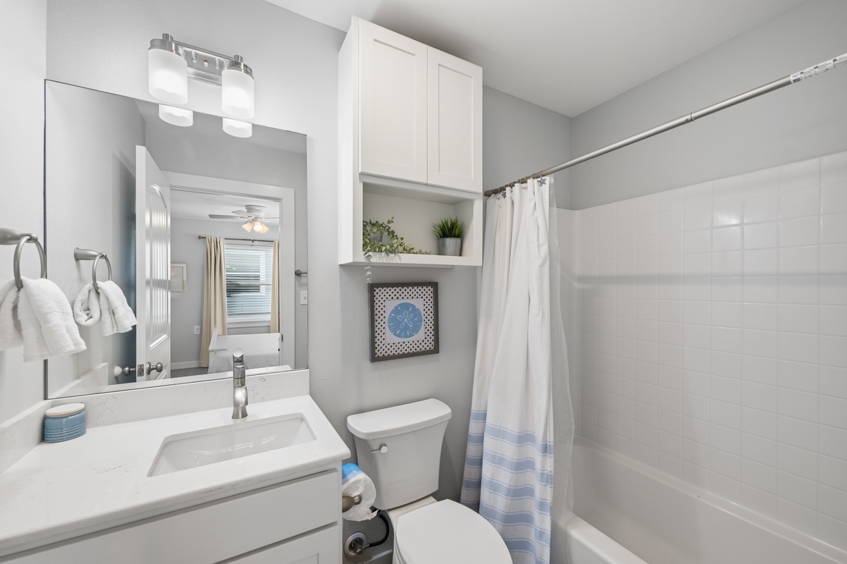 Your private bathroom gleams with fresh white finishes, crisp linens, and smart storage. Start each day at the bright vanity before stepping into the tub/shower combo—simple comfort designed with you in mind.