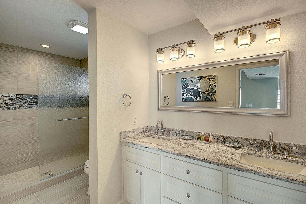 Your luxurious bathroom features dual vanities with granite counters and a spacious walk-in shower perfect for unwinding.