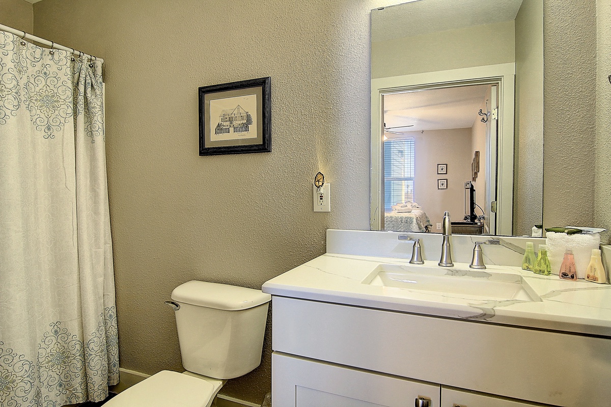 Freshen up in your private bathroom with elegant marble countertops and thoughtful amenities for a comfortable stay.
