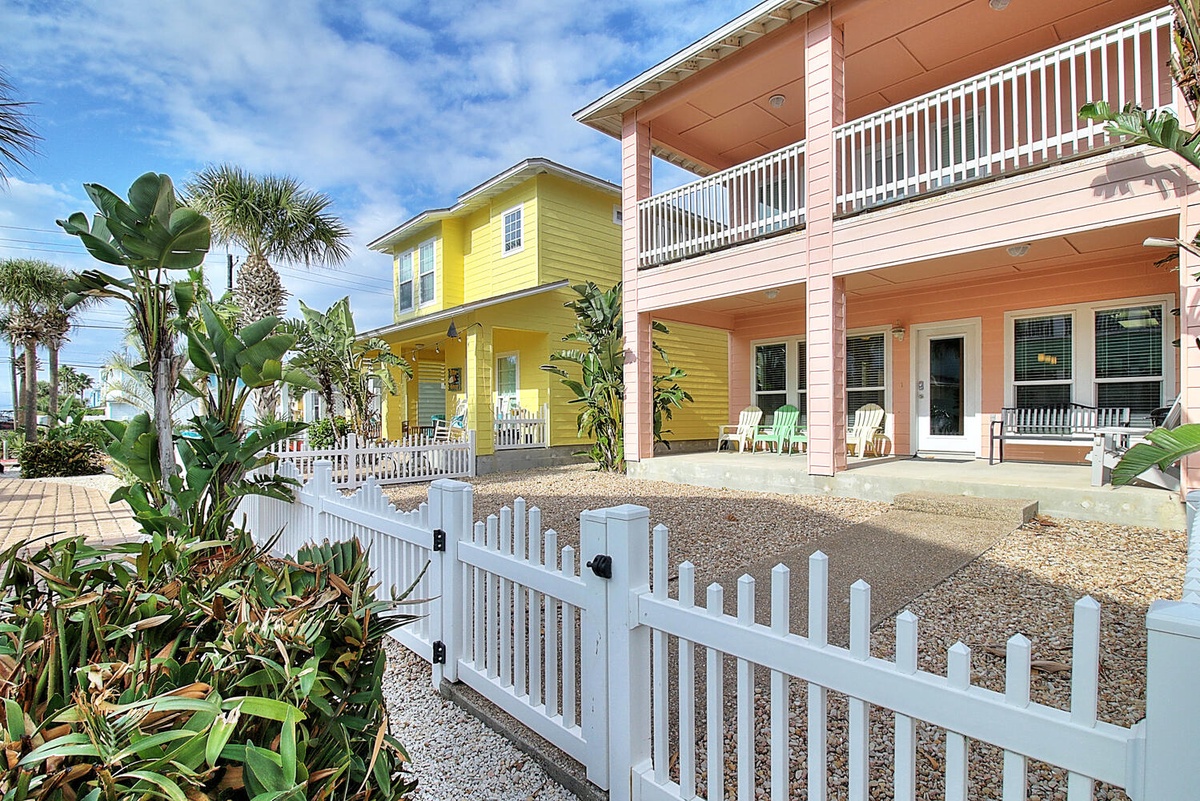 Charming coastal cottages feature vibrant tropical colors and welcoming front porches in this beachside neighborhood setting.