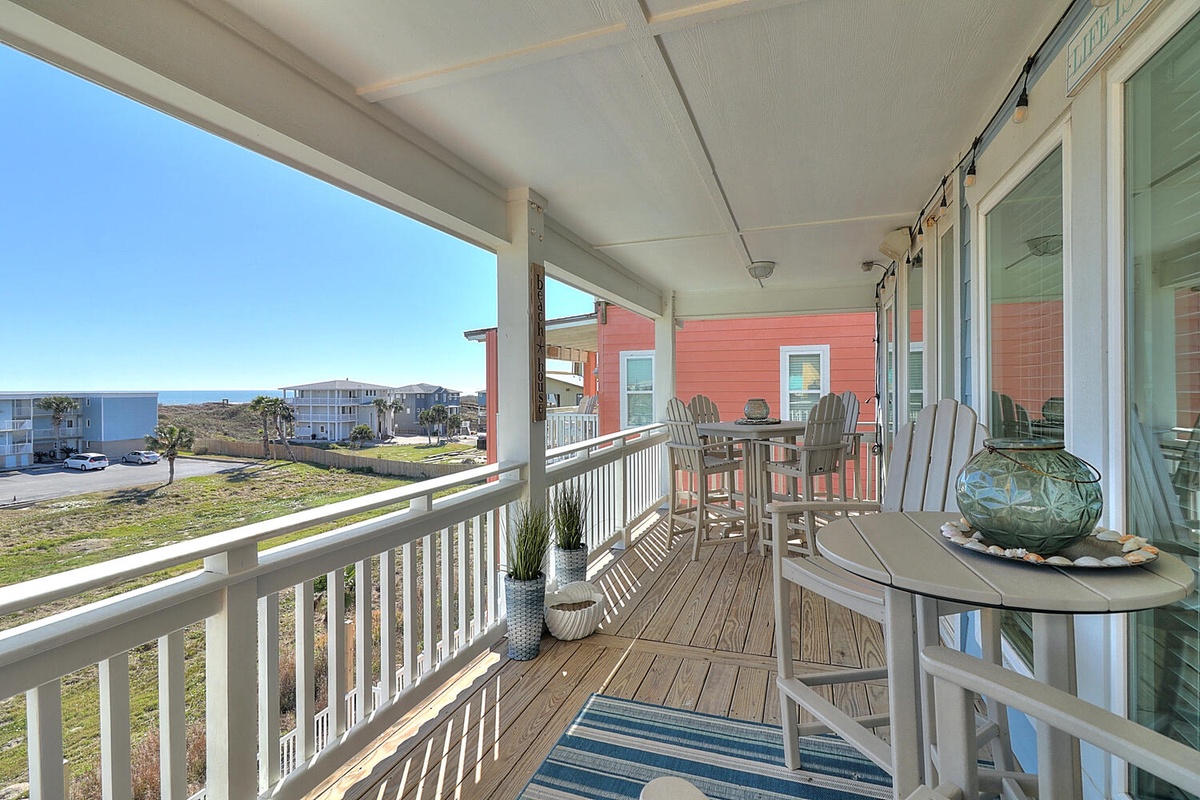Your covered balcony offers comfortable seating and coastal views, perfect for morning coffee or evening relaxation with ocean breezes.