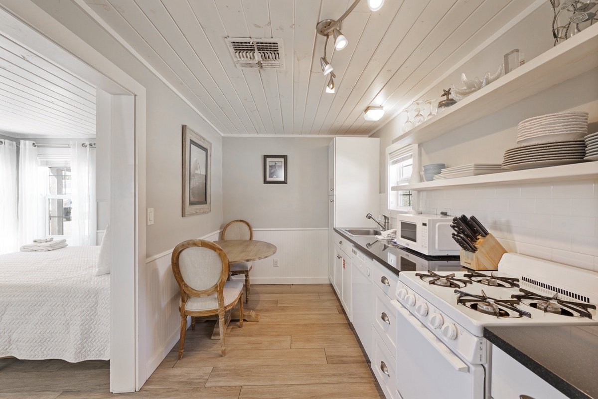 Your bright galley kitchen features modern appliances and charming wood beam ceilings, perfect for preparing meals during your stay.