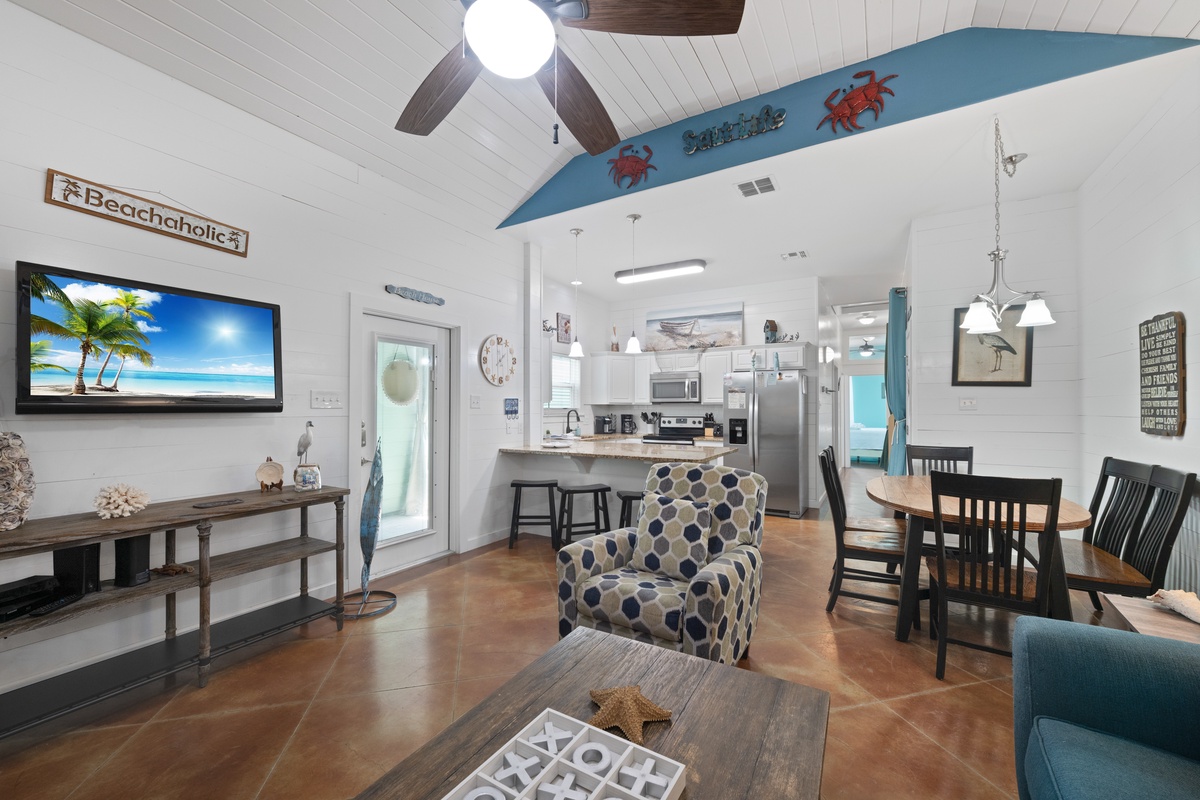 Relax in your beach-themed living space with coastal décor, modern kitchen, and open layout perfect for gathering.