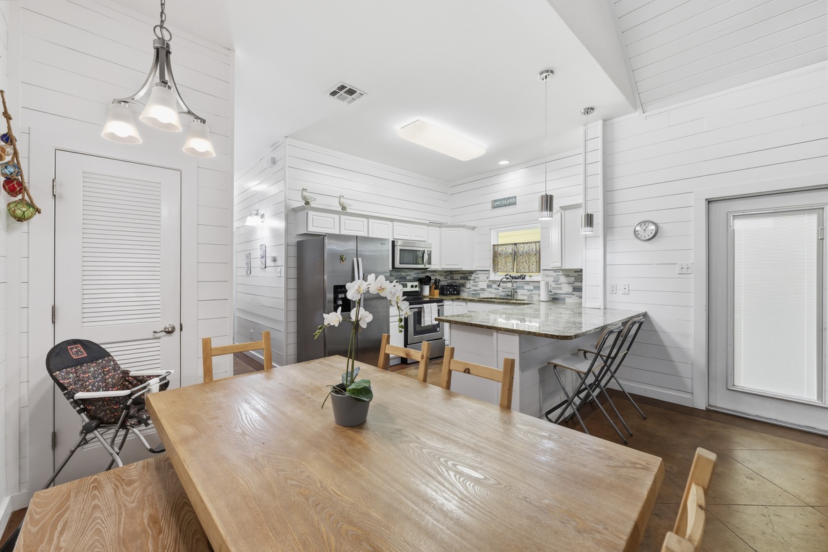 Your bright, open dining and kitchen space features modern appliances, granite countertops, and a welcoming table where you can enjoy meals together in comfort.