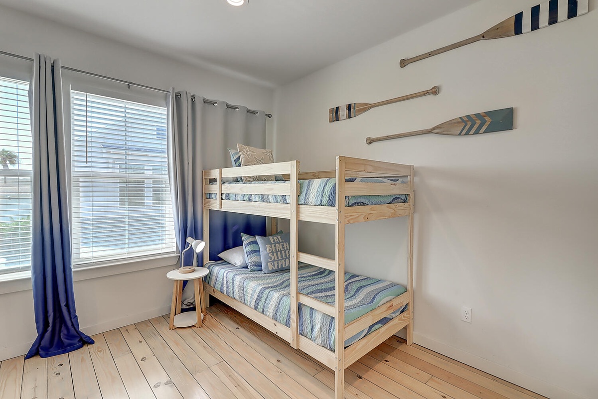 Your kids will love this cozy bunk bed room with charming nautical touches and plenty of natural light for bedtime stories.