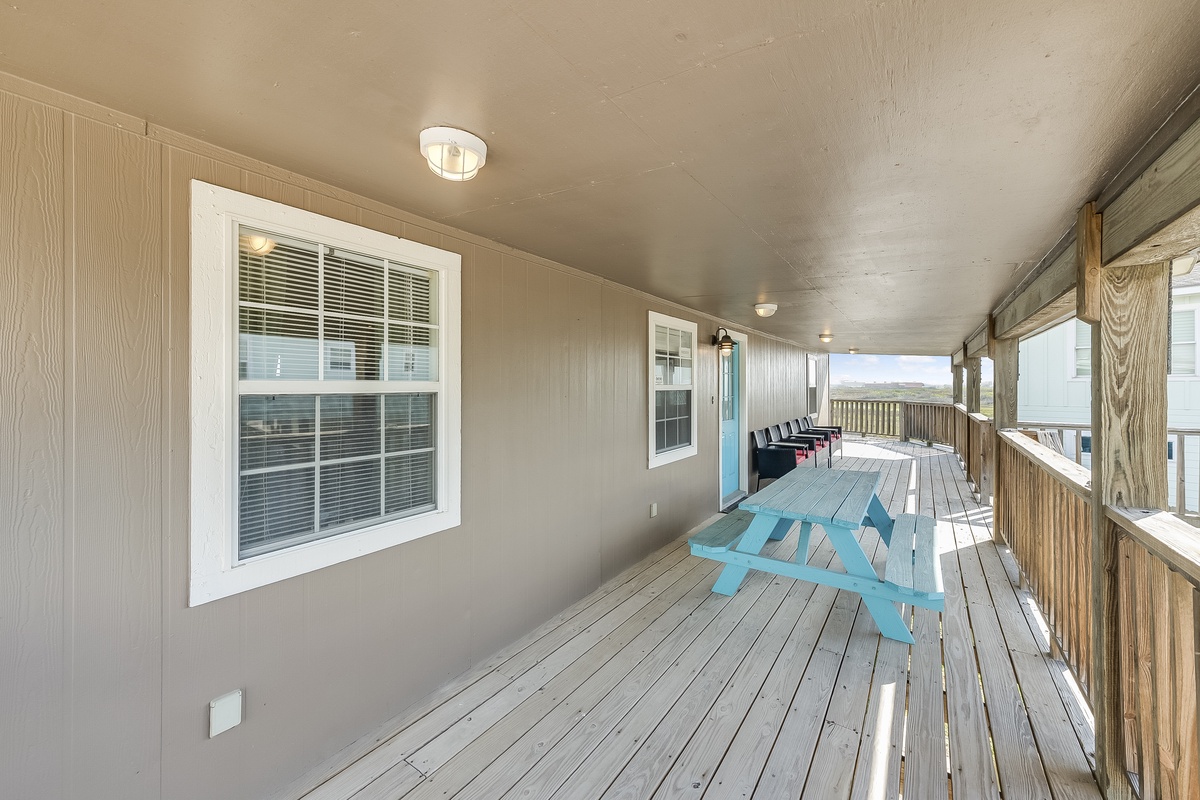 Relax on your spacious covered porch with turquoise picnic table, perfect for morning coffee or evening meals while enjoying the peaceful views.