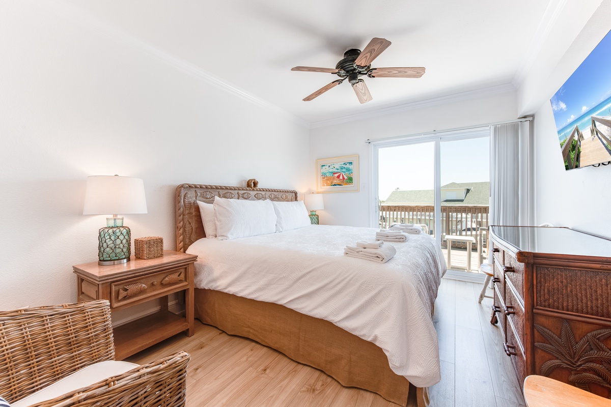 Drift off in your coastal-themed bedroom with crisp linens and a private balcony overlooking peaceful surroundings.