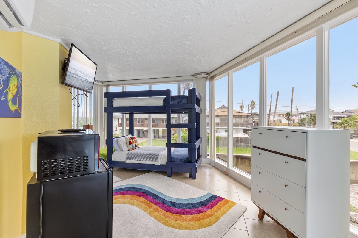 Your kids will love the colorful bunk bed by floor-to-ceiling windows, while you enjoy the bright, cheerful space with TV.