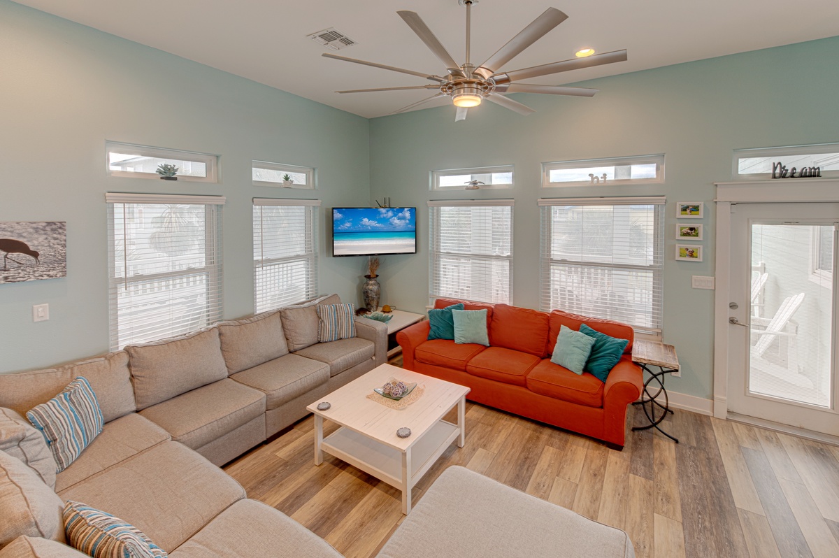Unwind in your bright, airy living room with comfortable seating for everyone and soothing coastal colors.