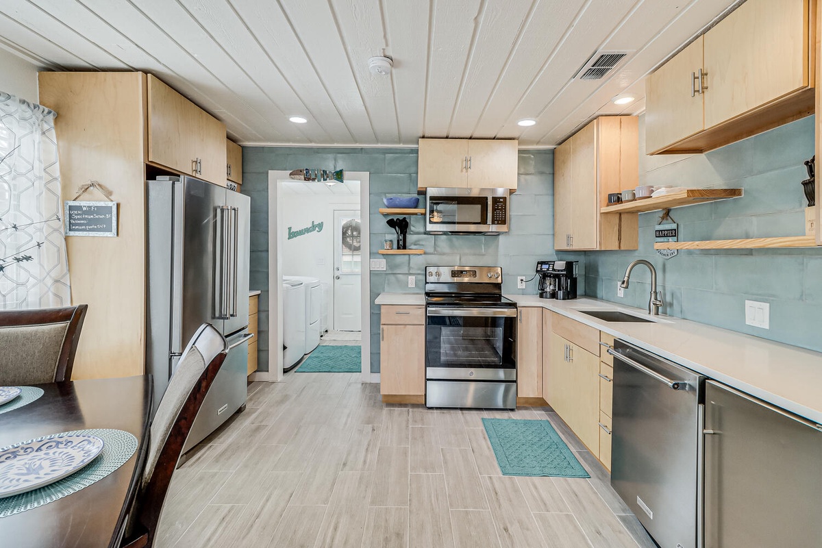 Your fully equipped kitchen features modern appliances and coastal charm, perfect for preparing meals during your stay.