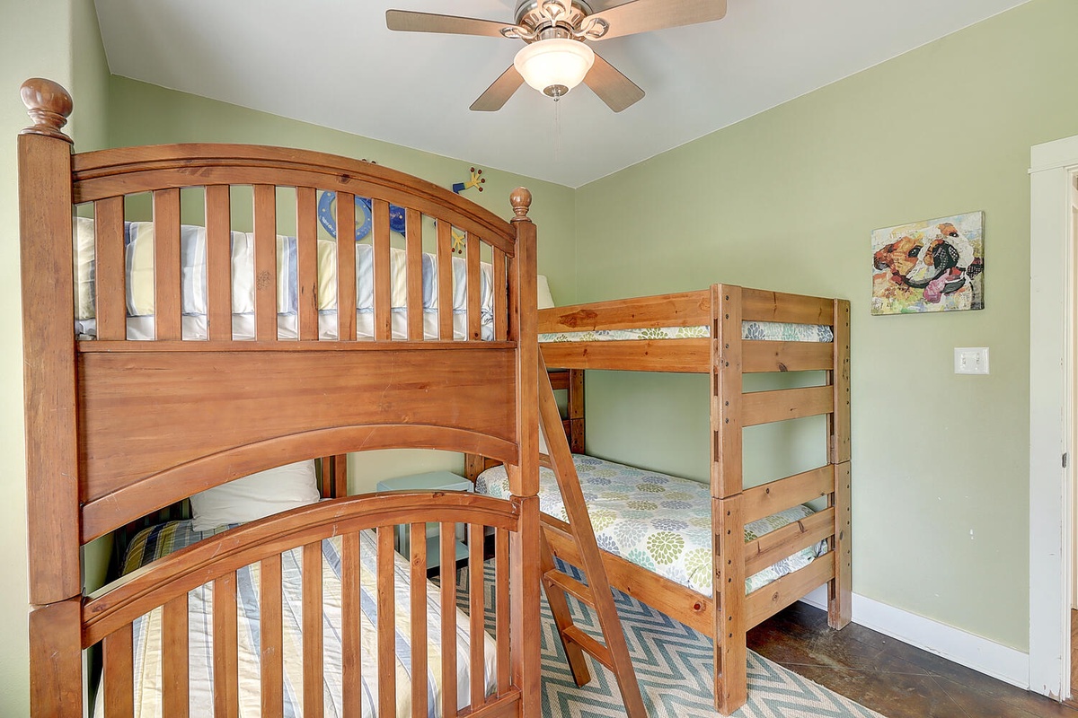 Your kids will love this cozy bedroom with sturdy bunk beds and cheerful green walls, perfect for family adventures.
