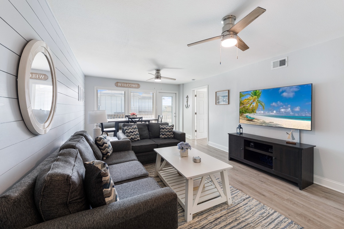 Unwind in your coastal living room with plush sectional seating and stunning flat-screen entertainment ready for relaxing evenings.