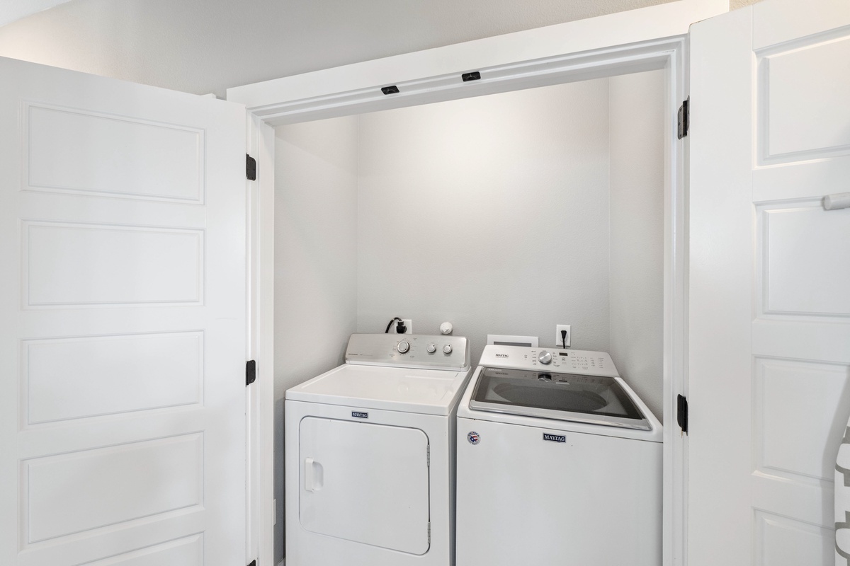 Your private laundry closet keeps your wardrobe fresh with modern washer and dryer tucked away behind elegant sliding doors.