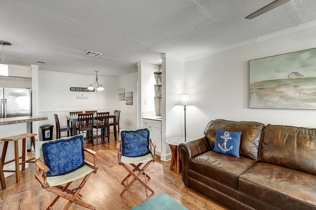 Sink into coastal comfort in your open living space, where nautical touches and rich leather seating create your perfect beach retreat sanctuary.