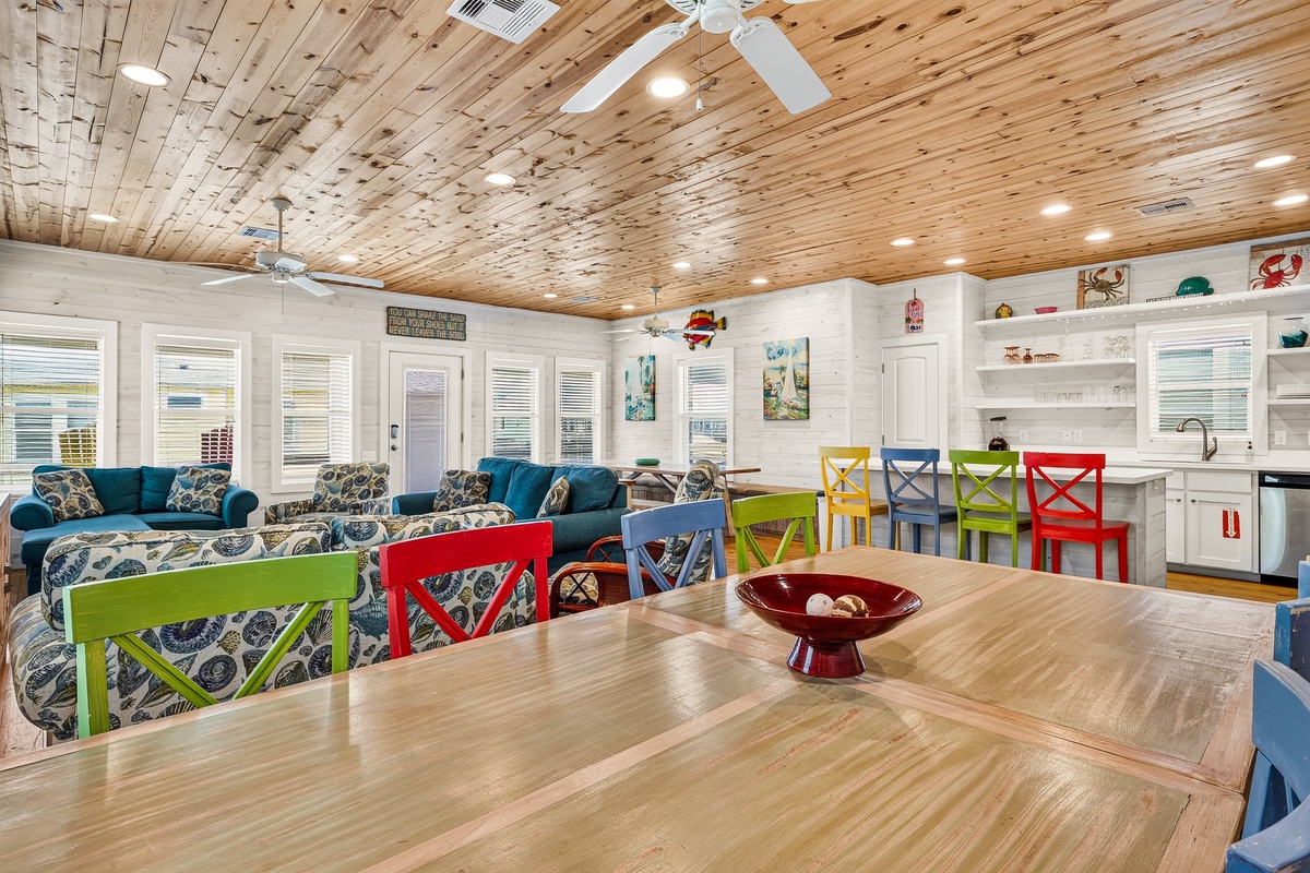 Gather around the spacious dining table and soak in the bright, airy feel of this open living space. You'll love the rustic wood ceiling, colorful seating, and cozy furnishings that make it easy to relax and connect.