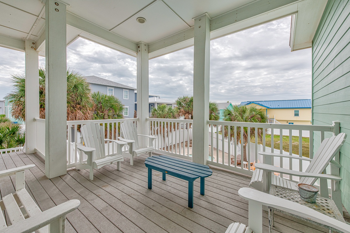 Relax on your private covered deck with Adirondack chairs, watching palm trees sway while you sip morning coffee or evening cocktails in coastal serenity.
