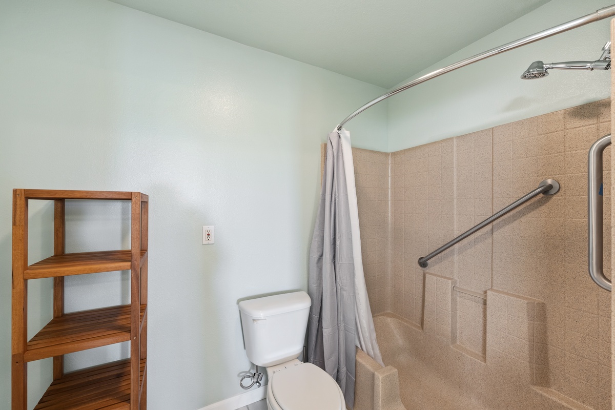 Step into your spa-like bathroom where thoughtful accessibility meets relaxation. The tub/shower combo with safety grab bars and crisp linens await your morning refresh.