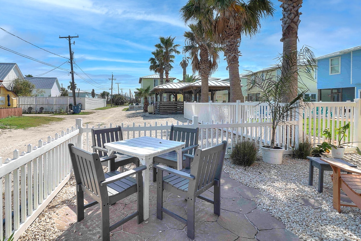 Your private patio offers the perfect spot for morning coffee surrounded by tropical palms and coastal charm.