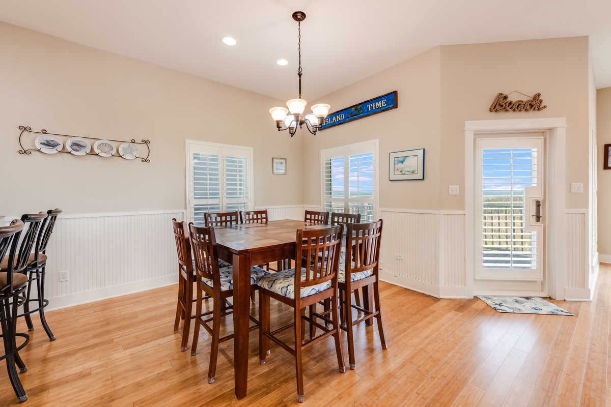 Gather around the spacious dining table where family meals become cherished memories, with coastal charm and natural light flowing through plantation shutters.