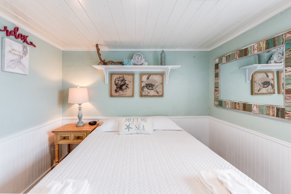 Drift off in this charming coastal bedroom where soft sea-green walls and rustic nautical touches create your perfect seaside retreat.